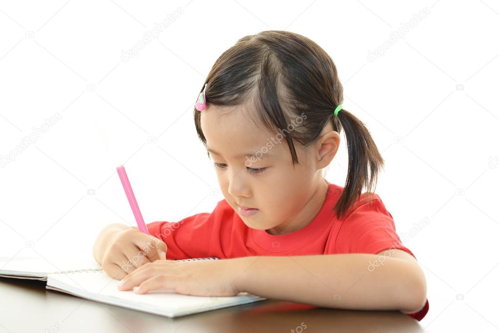 Little girl studying at the desk