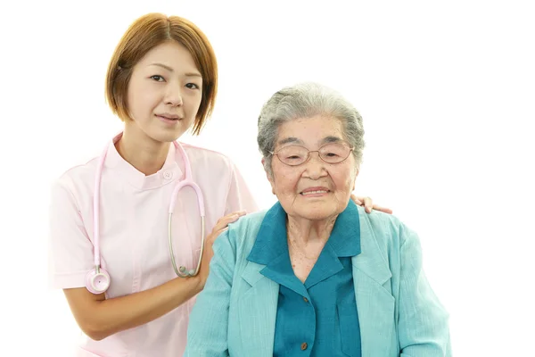 Smiling Asian medical doctor and senior woman — Stock Photo, Image