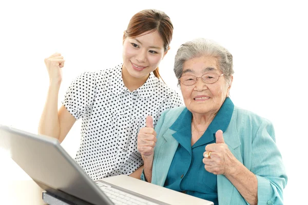 Old woman enjoys computer — Stock Photo, Image