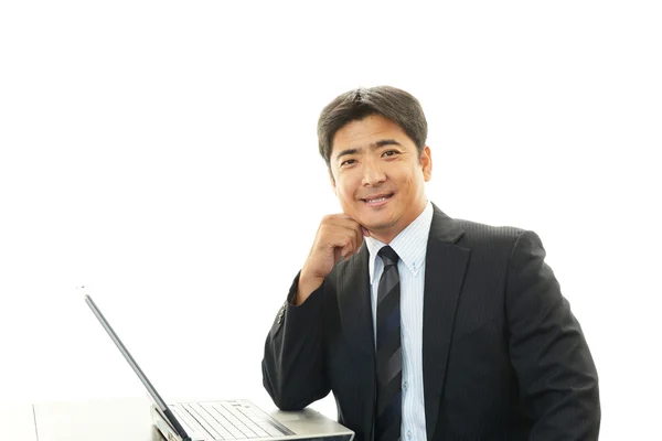 Smiling businessman with laptop — Stock Photo, Image