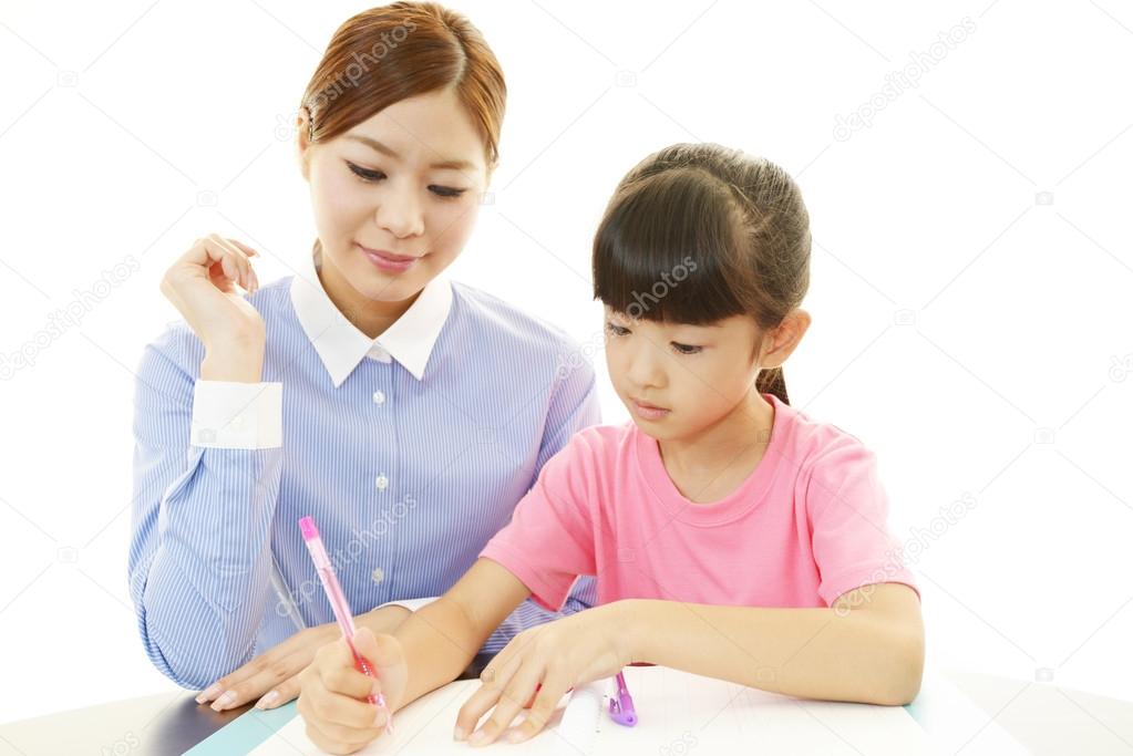 Young student studying with teacher