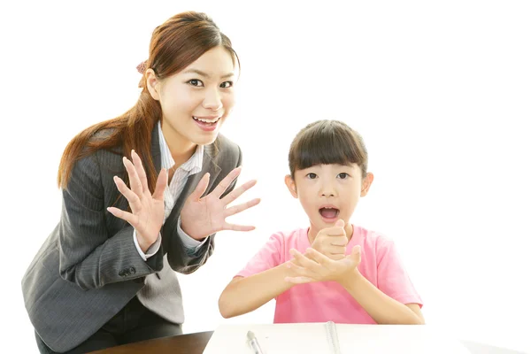 Young student studying with teacher — Stock Photo, Image