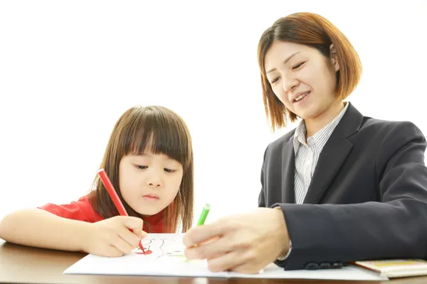 Young student studying with teacher — Stock Photo, Image