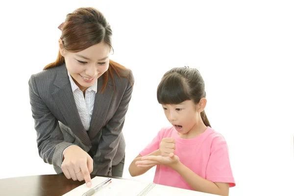 Young student studying with teacher — Stock Photo, Image