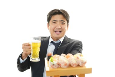 Man with beer and sushi