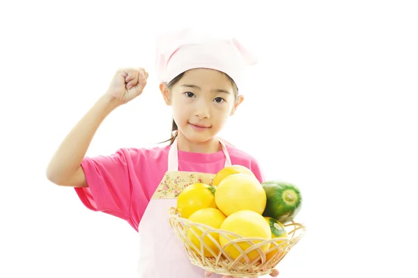 Smiling Asian girl with fruits — Stock Photo, Image