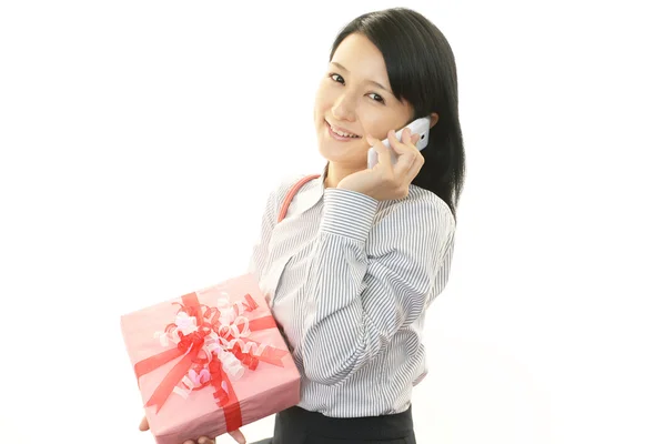 Mulher sorridente com um presente — Fotografia de Stock