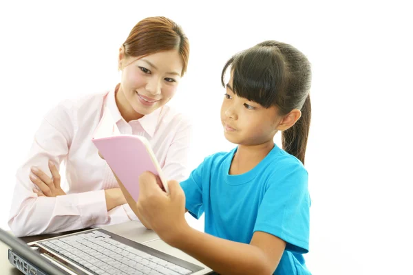 Young student studying with teacher — Stock Photo, Image