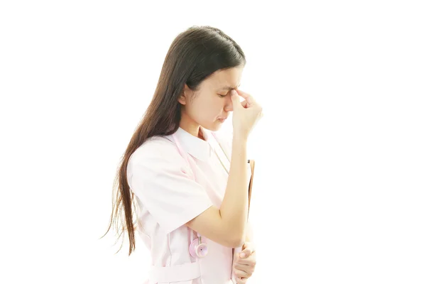 Enfermeira com dor de cabeça — Fotografia de Stock