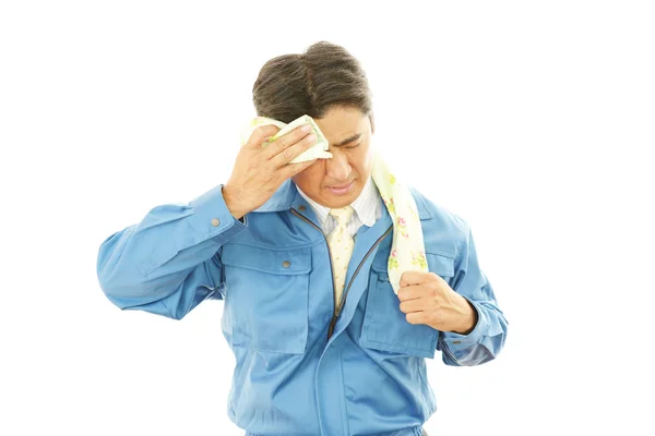 Tired and stressed Asian worker — Stock Photo, Image