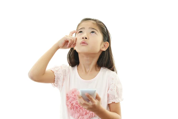 Portrait of an Asian schoolgirl with a smartphone — Stock Photo, Image