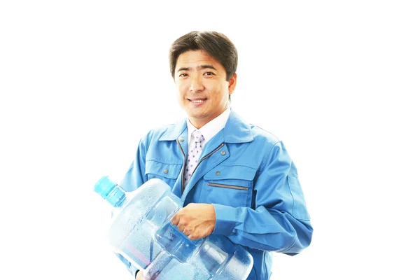 Worker with a container of water — Stock Photo, Image