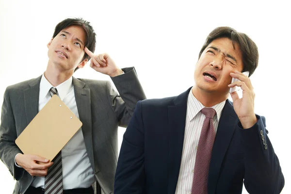 Stressed Asian businessmen — Stock Photo, Image