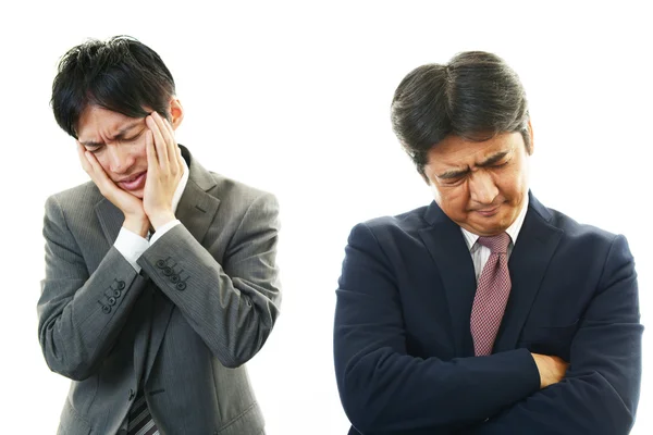 Stressed Asian businessmen — Stock Photo, Image