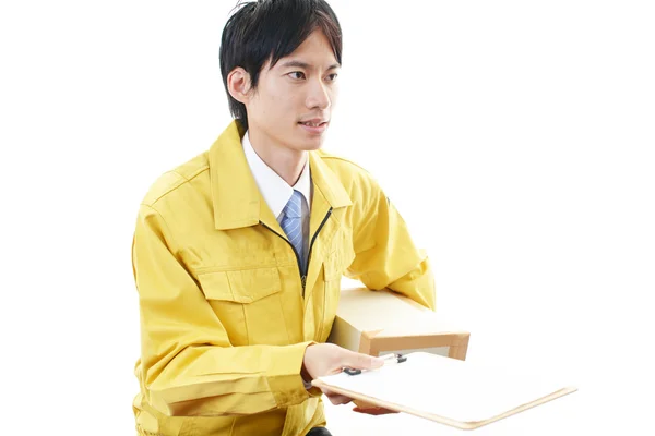 Asian courier delivering a package — Stock Photo, Image