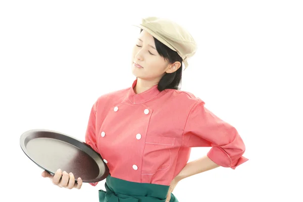 Tired young Asian waitress — Stock Photo, Image