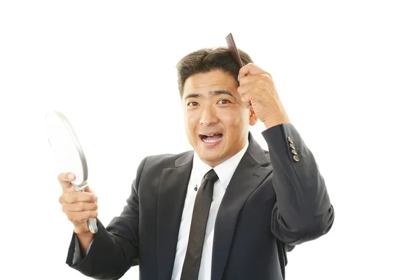 Man taking care of his hair — Stock Photo, Image