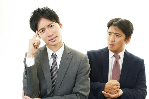 Stressed Asian businessmen — Stock Photo, Image