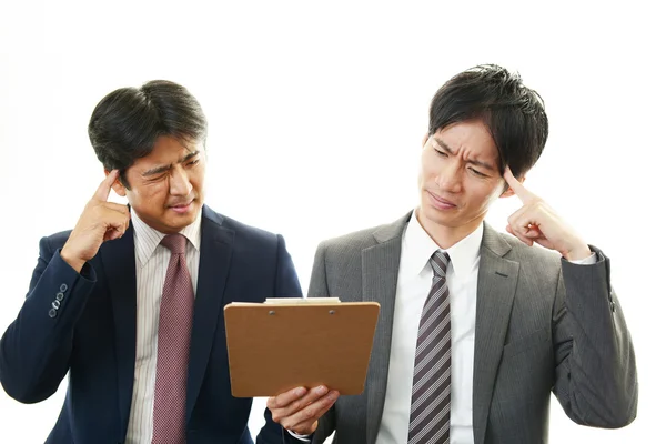 Stressed Asian businessmen — Stock Photo, Image