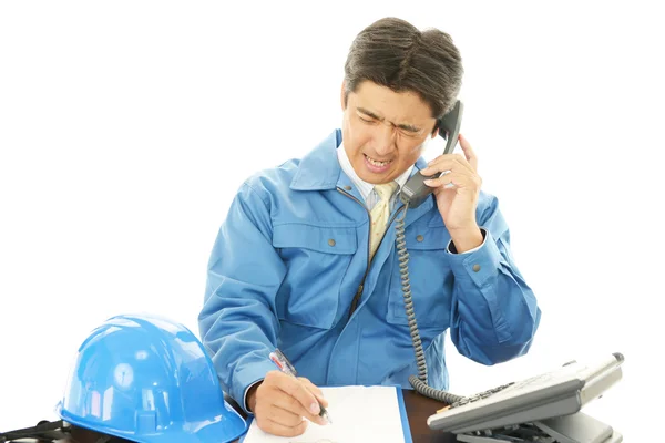 Tired and stressed Asian worker — Stock Photo, Image