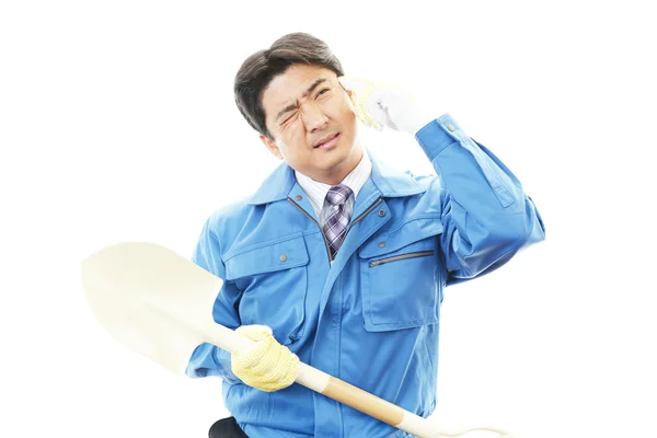 Tired and stressed Asian construction worker — Stock Photo, Image