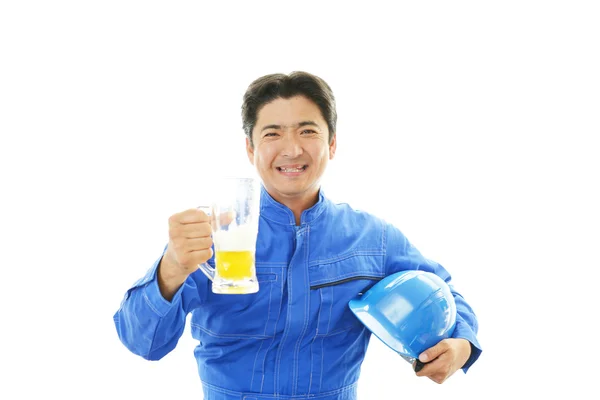 Asian worker drinking beer — Stock Photo, Image