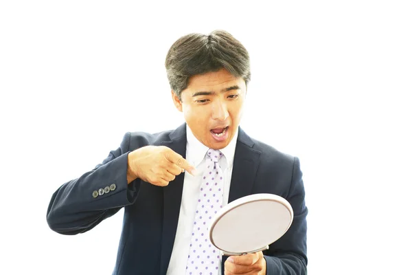 Businessman with a mirror — Stock Photo, Image