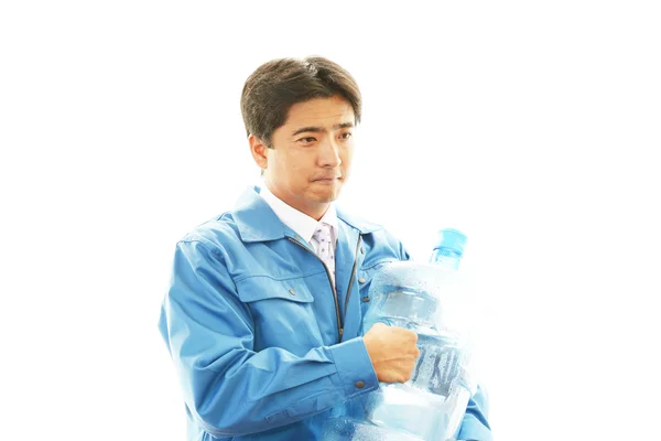 Worker with a container of water — Stock Photo, Image