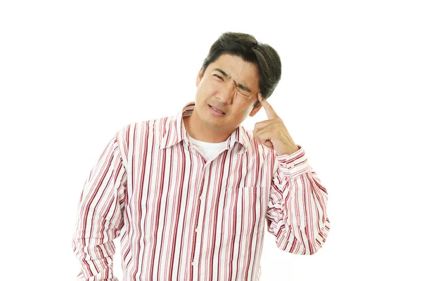 Aziatische man met een hoofdpijn — Stockfoto