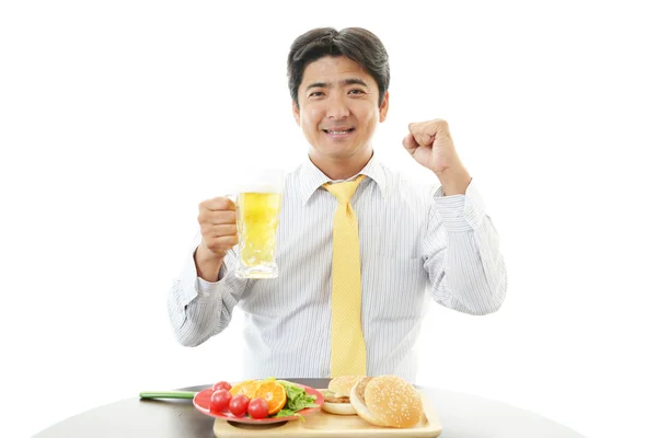 Businessman enjoys beer — Stock Photo, Image