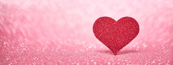 Valentines Day web banner with red heart, love symbol on pink sparkle background. Stock Picture