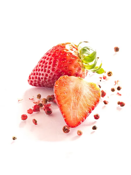 Strawberries with red peppercorns — Stock Photo, Image