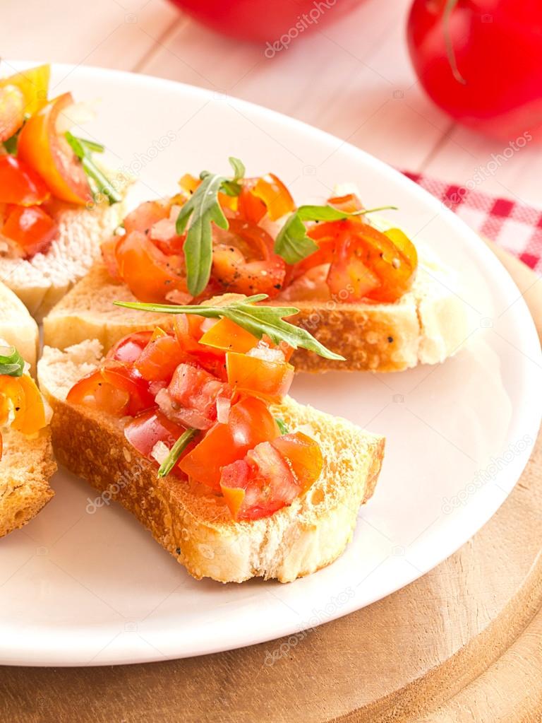 Bruschetta from tomatoes and rucola