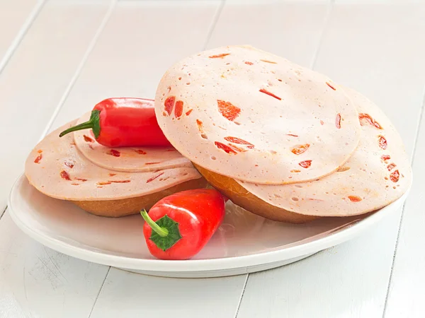 Roll filled with sausage slices — Stock Photo, Image