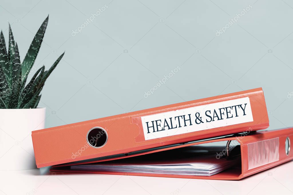 Health and safety labor protection and regulations at work place. Folder with documents or instructions. employees and their rights. Guidance or induction. Copy space. Office desk