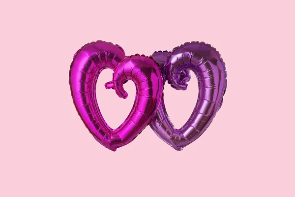 Dva balónky ve tvaru fóliového srdce na růžové — Stock fotografie