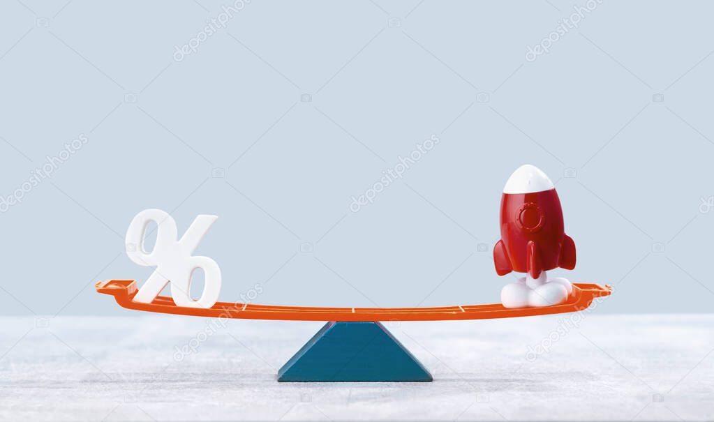 Financial growth concept. Rocket with percentage signon balance scale