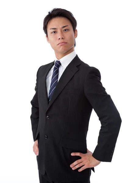 Young businessman thinking by placing a hand on the waist — Stock Photo, Image