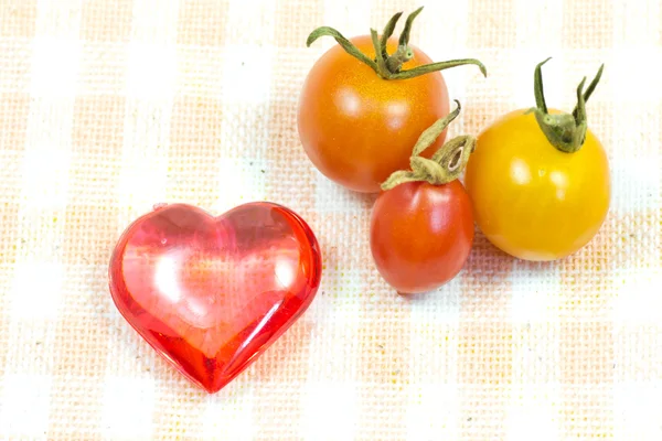 Cherry tomatoes and red heart — Stock Photo, Image