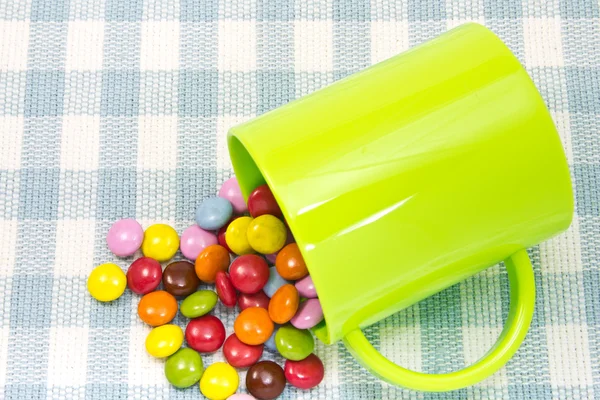 Colorful chocolate and mug — Stock Photo, Image