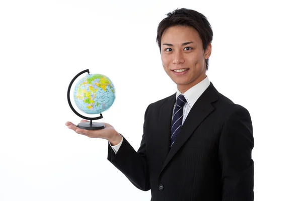 Young businessman with a globe — Stock Photo, Image