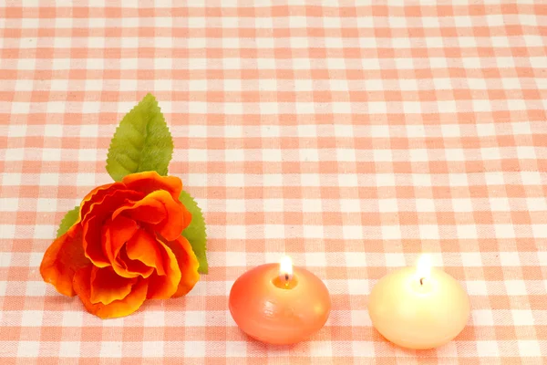 Artificial rose and candles — Stok fotoğraf