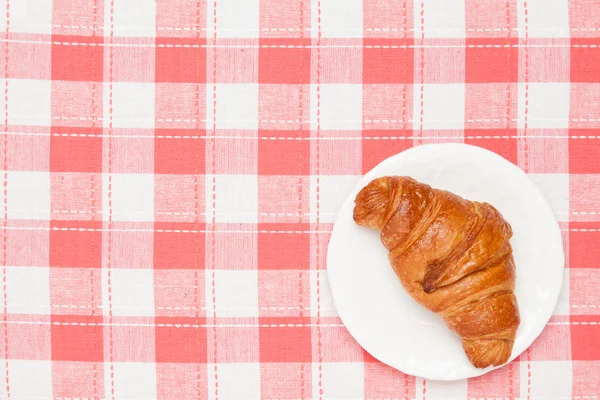 Croissant on the table cloth — Stock Photo, Image