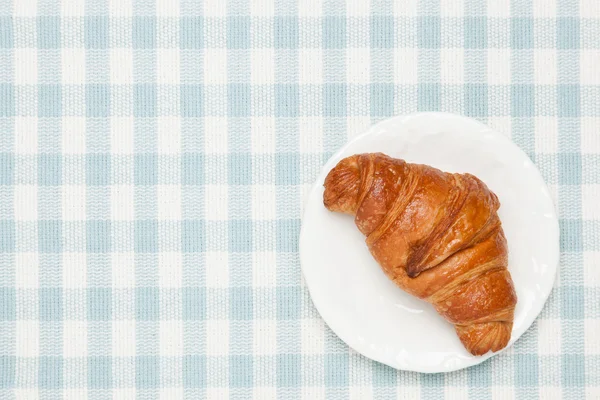 Croissant na toalha de mesa — Fotografia de Stock