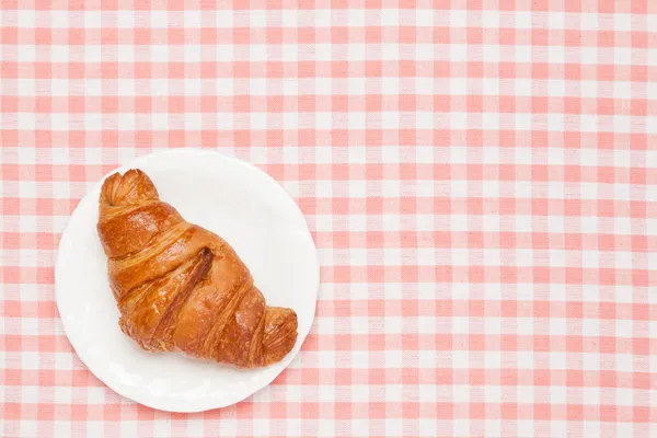 Croissant auf der Tischdecke — Stockfoto