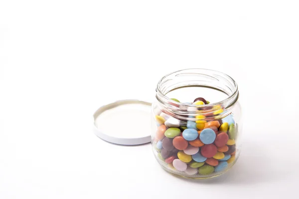 Colorful chocolate was placed in a glass bottle — Stock Photo, Image