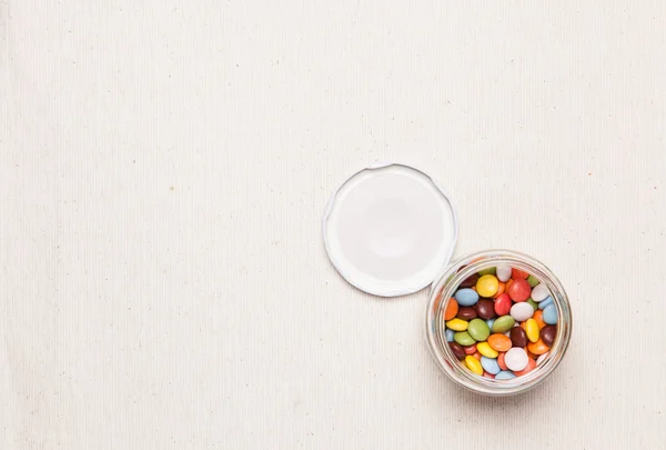 Colorful chocolate was placed in a glass bottle — Stock Photo, Image