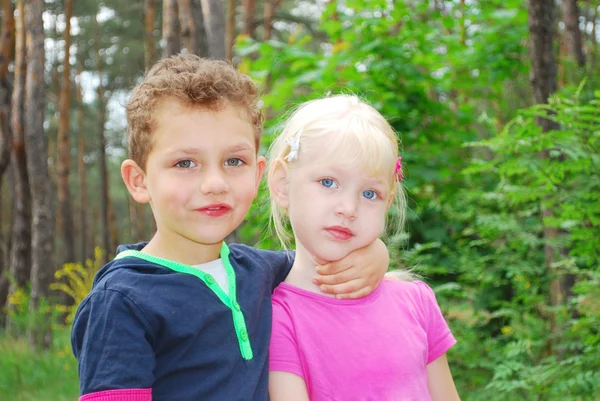 Boy gently hugs the girl's neck, they are happy, smiling. — Stock Photo, Image