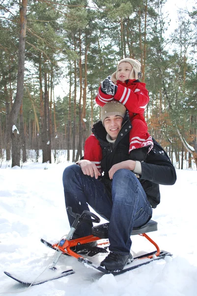 Winter in the woods dad holding his son on his shoulders. — Stock Photo, Image