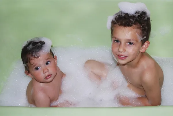 Brother and sister bathed in a bubble bath. — Stock Photo, Image